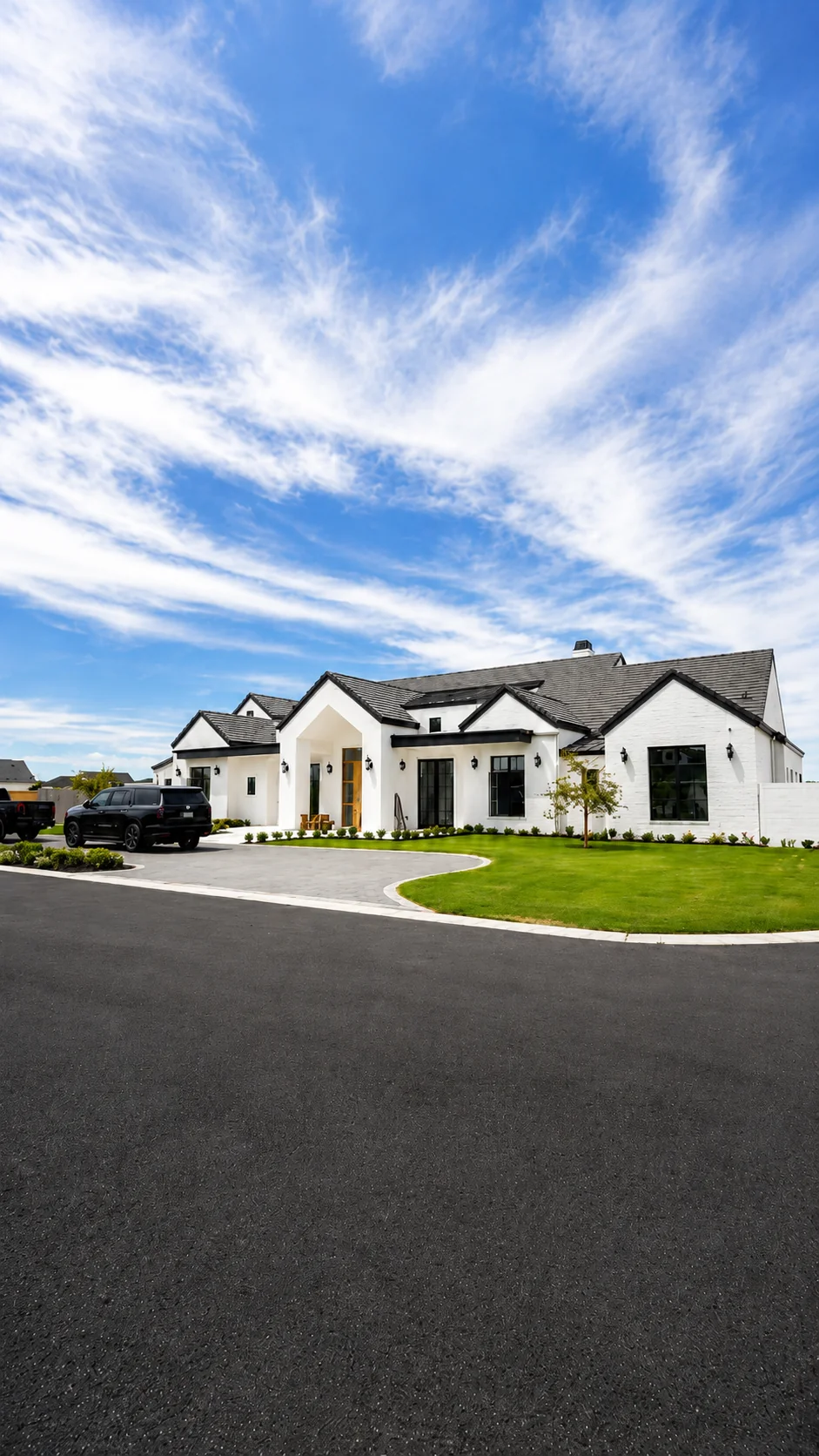 A modern single-story white home built by AFT Construction, protected by Hydrology whole home filtration